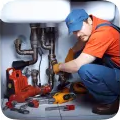 Plumber repairing pipes with tools